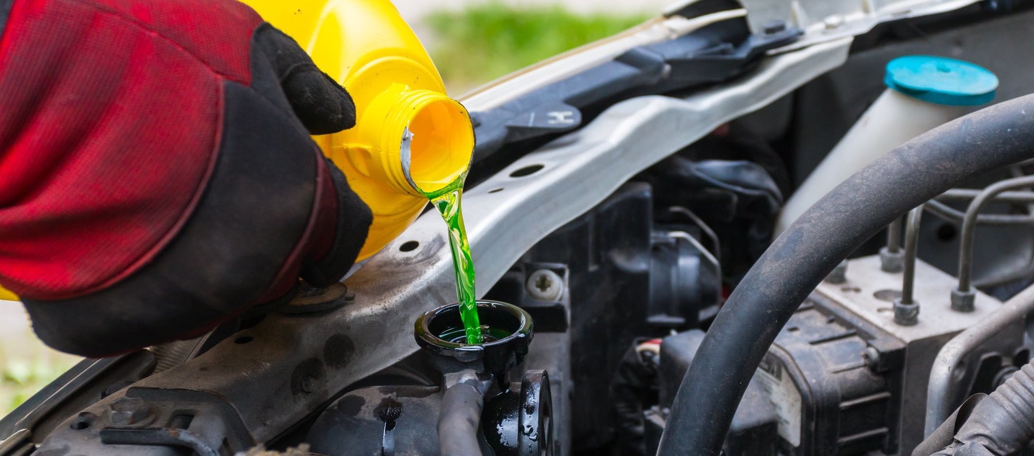 service technician pouring coolant